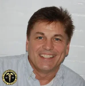 A man with a white shirt and brown hair.