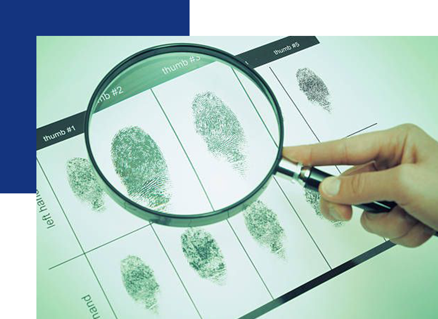 A person is looking at fingerprints through a magnifying glass.
