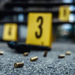 A bullet casing and some yellow signs on the ground