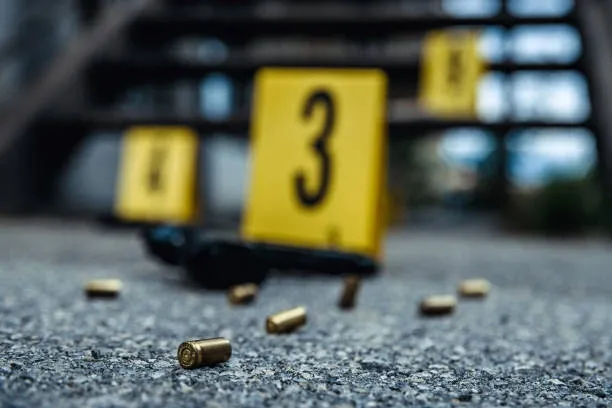 A bullet casing and some yellow signs on the ground