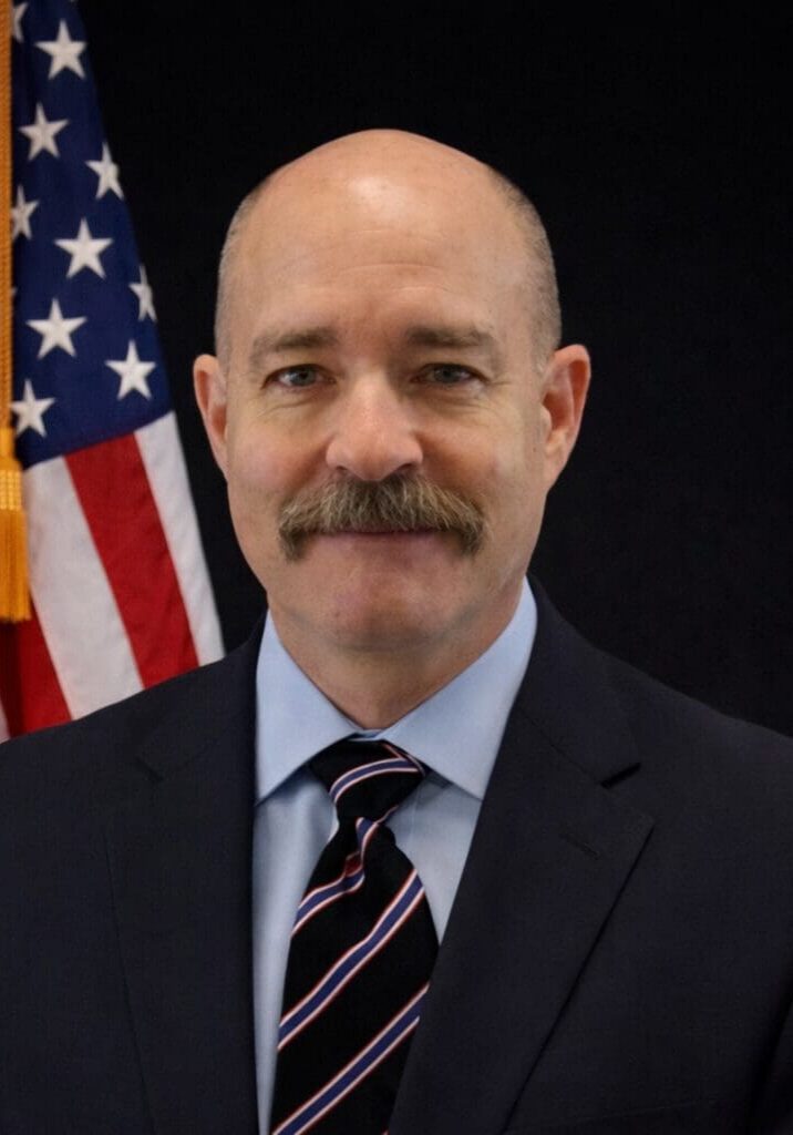 Stately mustached man in business suit portrait