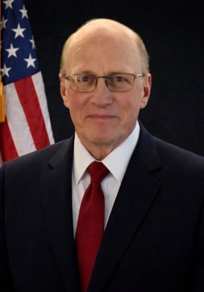 Genteel bespectacled man in red tie portrait