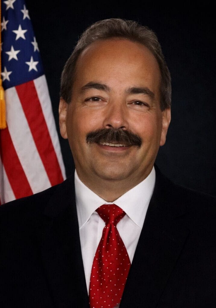 Mustached man wearing red polka-dot tie