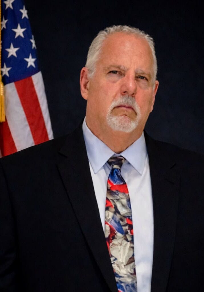 White-haired goateed man in suit